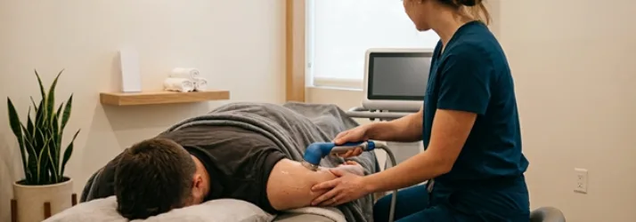 Chiropractor Grand Rapids MI Male Patient Receiving SoftWave Treatment