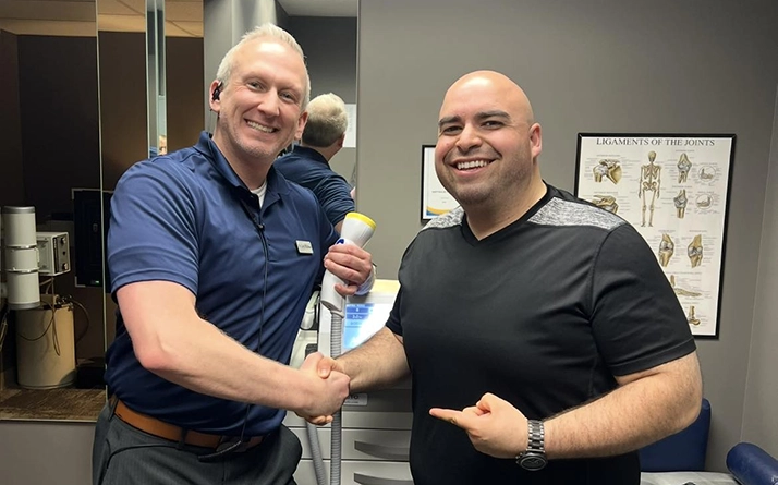 Chiropractor Grand Rapids MI Cory Wellman With Client